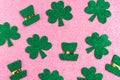 Happy St. PatrickÃ¢â¬â¢s Day. Green hat and shamrock pattern on pink glitter background.